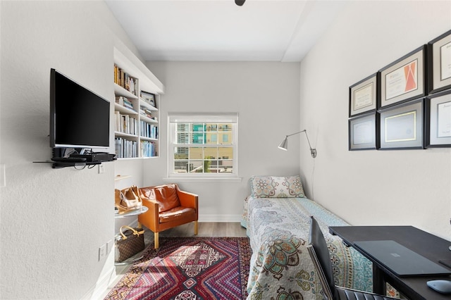 sitting room with wood finished floors and baseboards