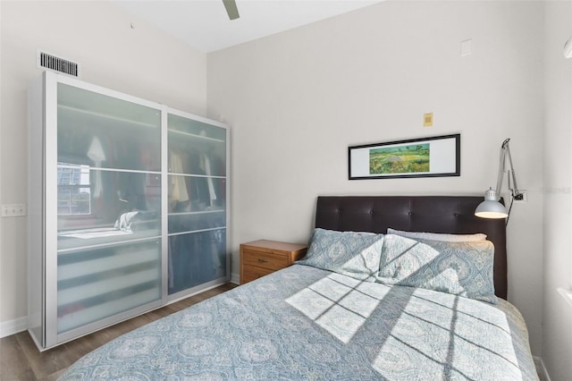 bedroom featuring wood finished floors, baseboards, and ceiling fan