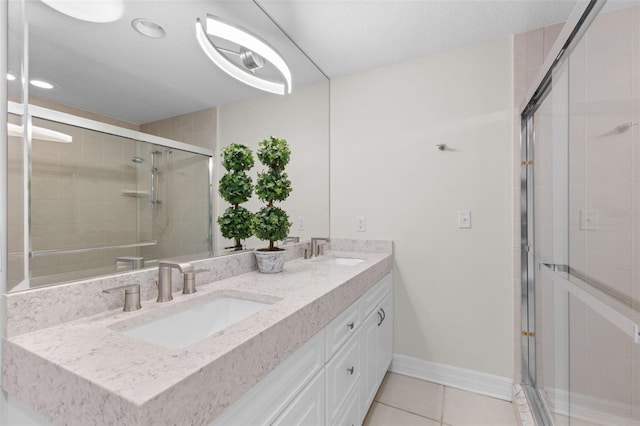 full bath with a shower stall, tile patterned flooring, baseboards, double vanity, and recessed lighting