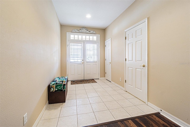 entryway with light tile patterned flooring