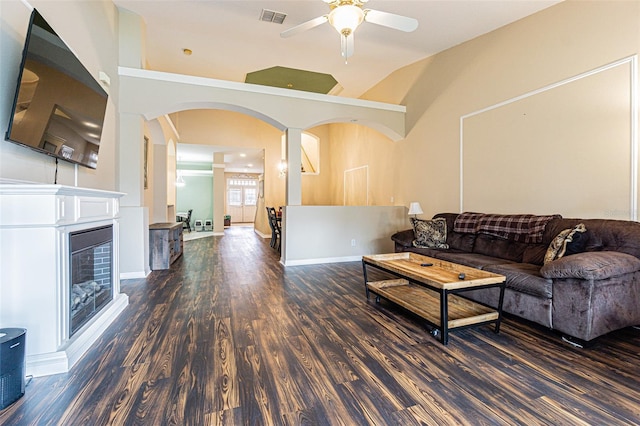 living room with ceiling fan and dark wood-type flooring