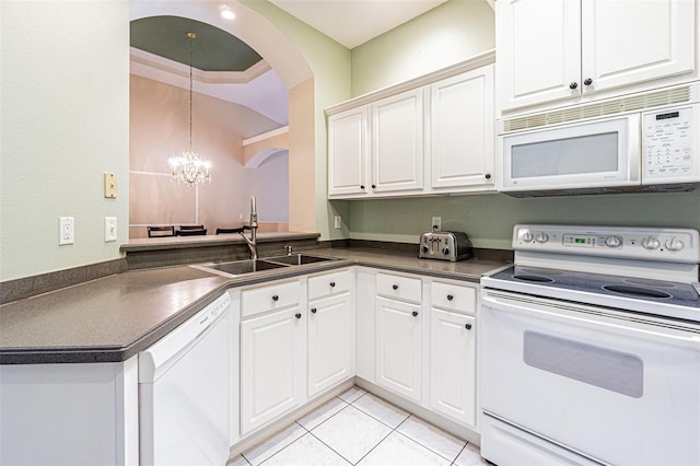 kitchen featuring white appliances, sink, light tile patterned floors, a notable chandelier, and white cabinetry