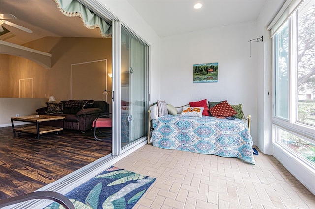 bedroom featuring multiple windows, ceiling fan, and lofted ceiling