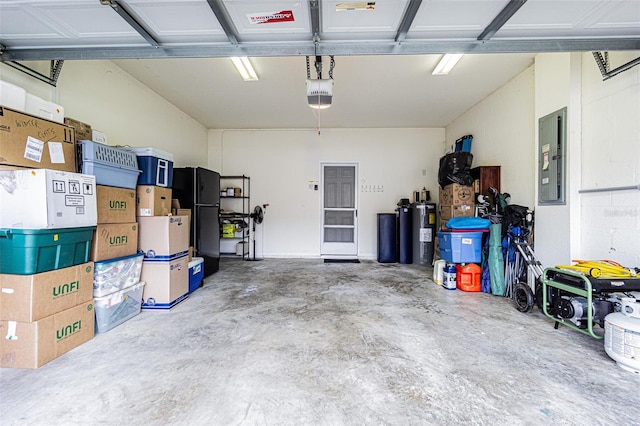 garage featuring electric panel and black refrigerator