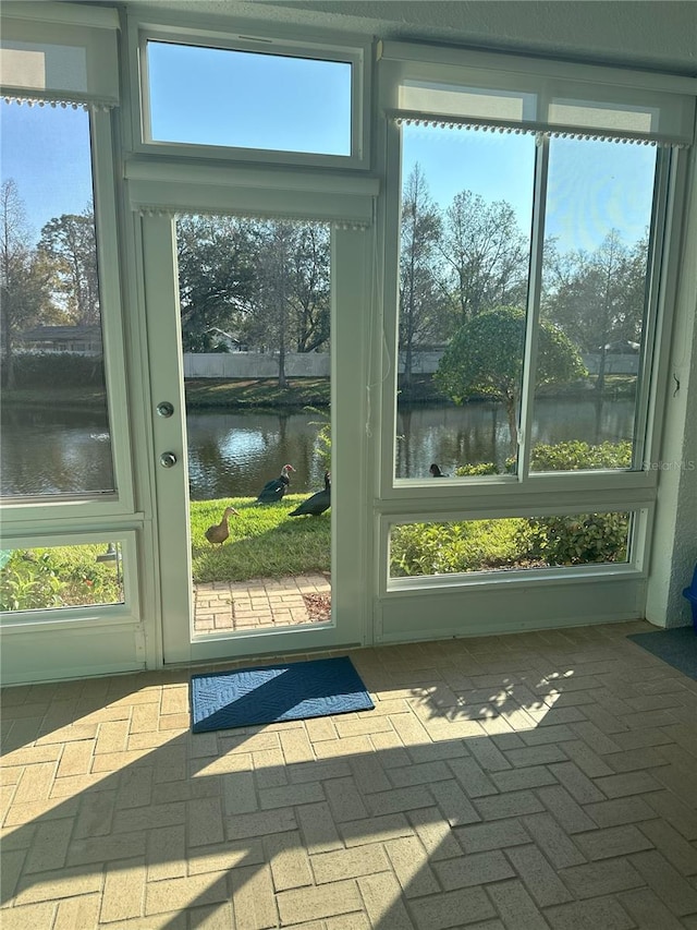 doorway to outside featuring a water view