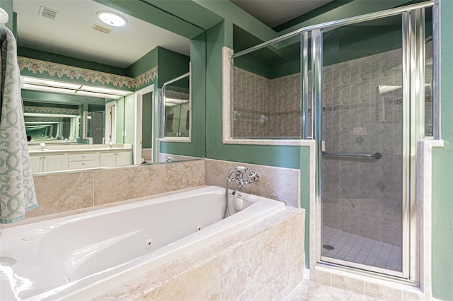 bathroom with shower with separate bathtub, vanity, and tile patterned floors