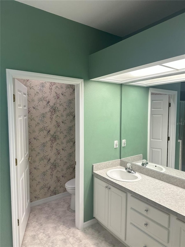 bathroom with vanity, toilet, and tile patterned flooring