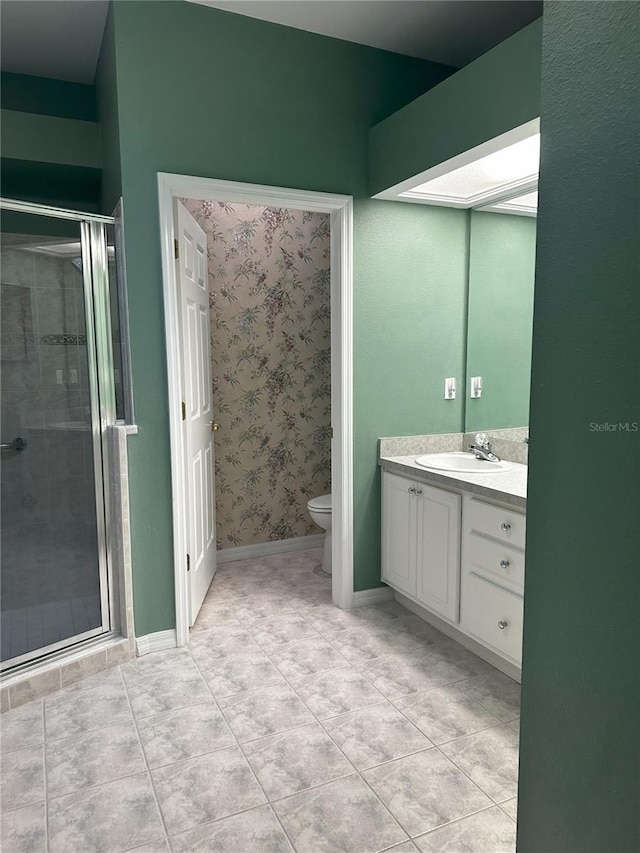 bathroom with vanity, toilet, an enclosed shower, and tile patterned flooring