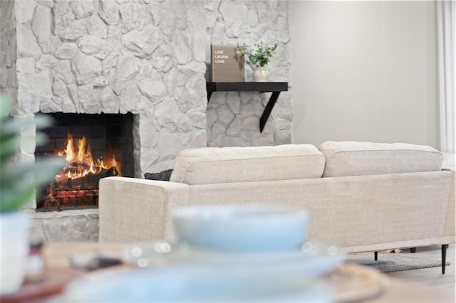 living room with a stone fireplace