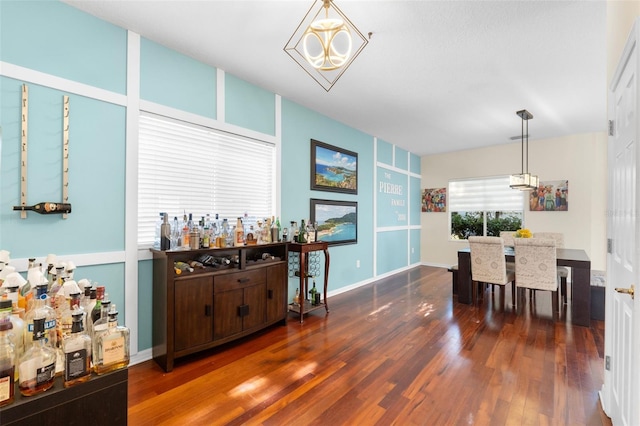 dining room featuring dark hardwood / wood-style floors and a chandelier