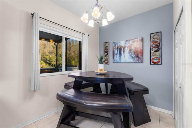 tiled dining space featuring an inviting chandelier