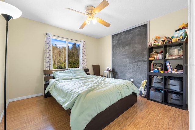 bedroom with ceiling fan and hardwood / wood-style flooring