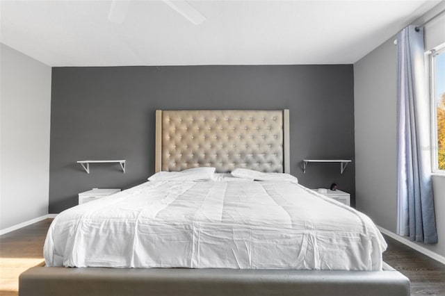 bedroom featuring ceiling fan and dark wood-type flooring