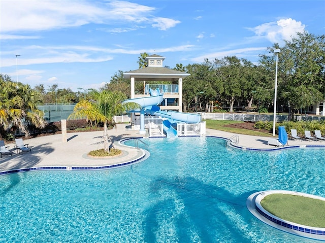 view of pool featuring a patio and a water slide