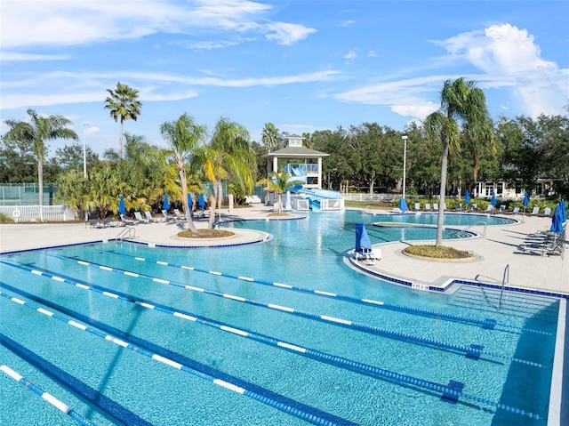 view of pool with a gazebo, a water slide, and a patio