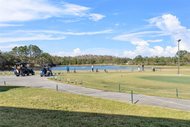 view of home's community featuring a water view and a lawn