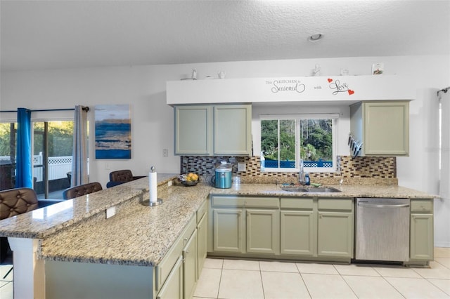 18127 Sandy Pointe Dr, Tampa, FL 33647 - kitchen featuring dishwasher, a sink, a peninsula, light tile patterned flooring, and a textured ceiling