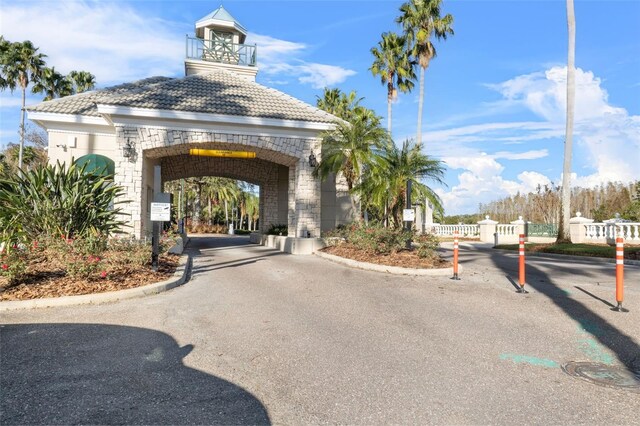 18127 Sandy Pointe Dr, Tampa, FL 33647 - view of asphalt road featuring curbs and a gated entry