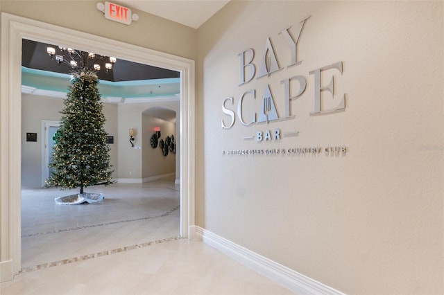 18127 Sandy Pointe Dr, Tampa, FL 33647 - corridor with tile patterned floors, a chandelier, and baseboards