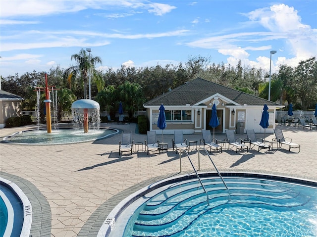 18127 Sandy Pointe Dr, Tampa, FL 33647 - view of swimming pool featuring a hot tub, fence, a patio area, and view of wooded area