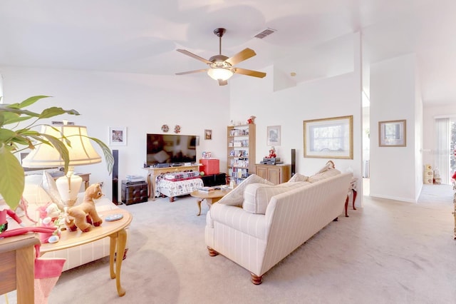 carpeted living room featuring high vaulted ceiling and ceiling fan