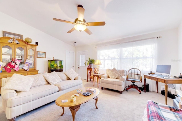 living room with ceiling fan, carpet floors, and lofted ceiling