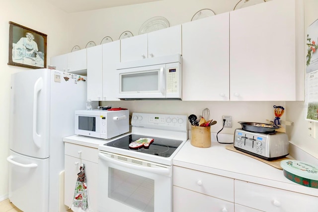 kitchen with white cabinetry and white appliances