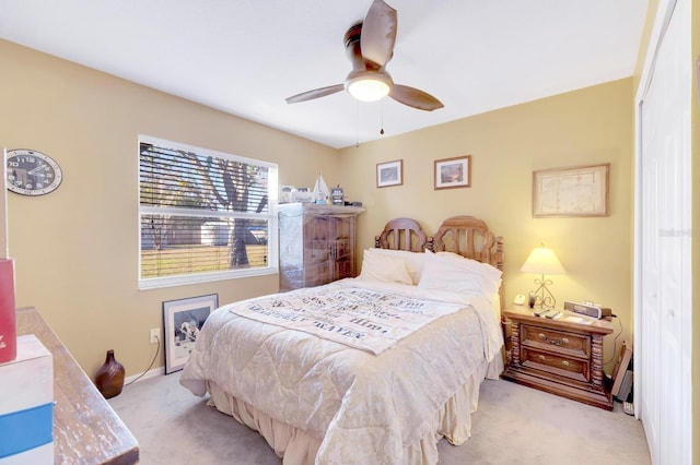 bedroom featuring light colored carpet and ceiling fan