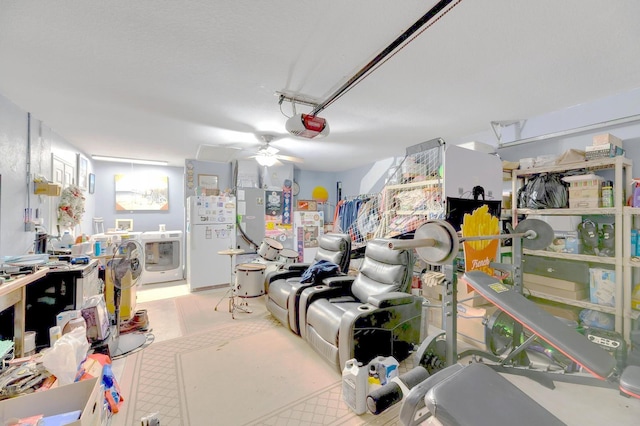 interior space featuring separate washer and dryer, white fridge, a garage door opener, and ceiling fan