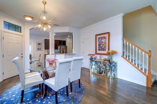 dining room featuring ornamental molding, dark wood-type flooring, and a notable chandelier