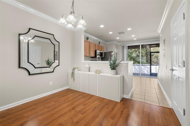 10334 Estero Bay Ln, Tampa, FL 33625 - kitchen featuring ornamental molding, recessed lighting, a chandelier, light wood-style flooring, and stainless steel appliances