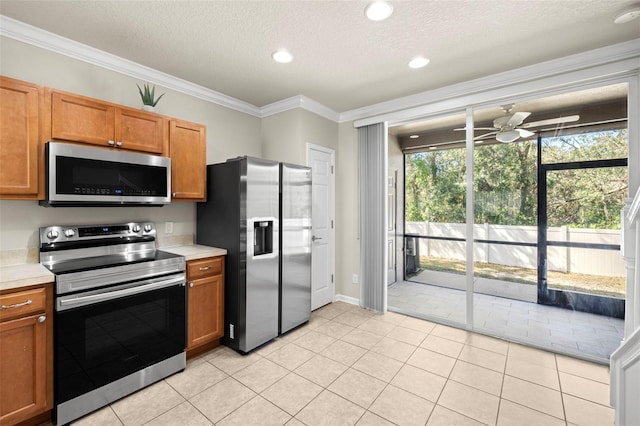 10334 Estero Bay Ln, Tampa, FL 33625 - kitchen featuring stainless steel appliances, light countertops, ceiling fan, crown molding, and a textured ceiling