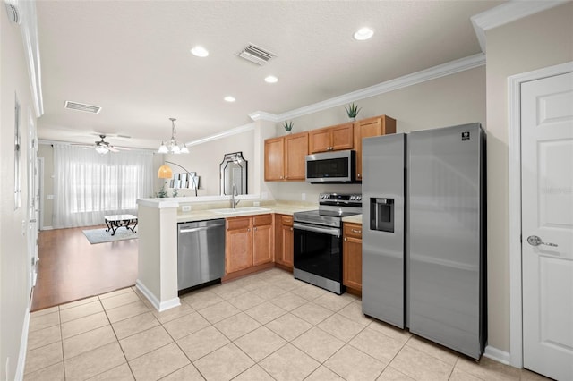 kitchen with kitchen peninsula, stainless steel appliances, ornamental molding, and sink