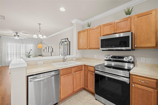 10334 Estero Bay Ln, Tampa, FL 33625 - kitchen featuring appliances with stainless steel finishes, a sink, crown molding, a peninsula, and light countertops
