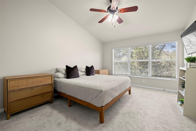 carpeted bedroom featuring multiple windows, lofted ceiling, and ceiling fan