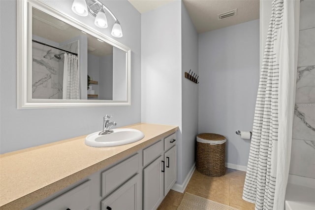 bathroom with tile patterned floors and vanity