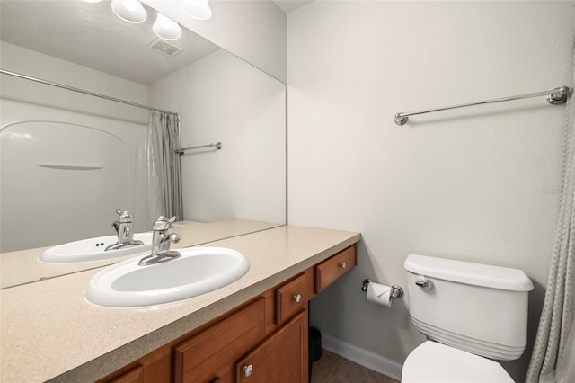 10334 Estero Bay Ln, Tampa, FL 33625 - bathroom featuring vanity, toilet, tile patterned flooring, curtained shower, and baseboards