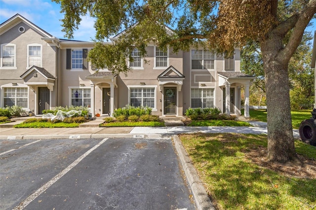 10334 Estero Bay Ln, Tampa, FL 33625 - view of property with stucco siding and uncovered parking