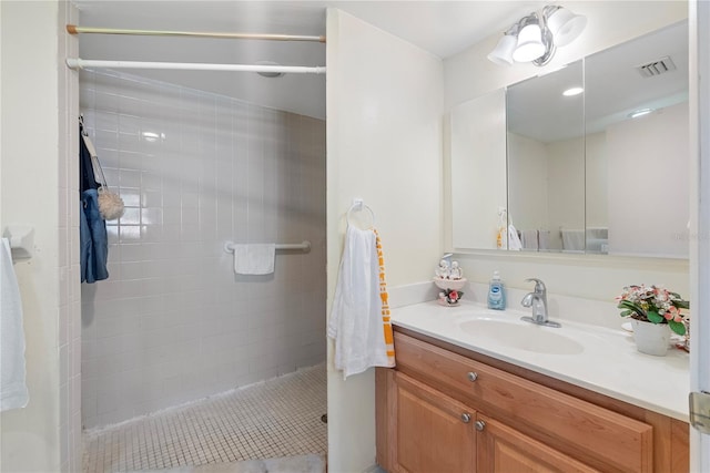 bathroom featuring vanity and tiled shower