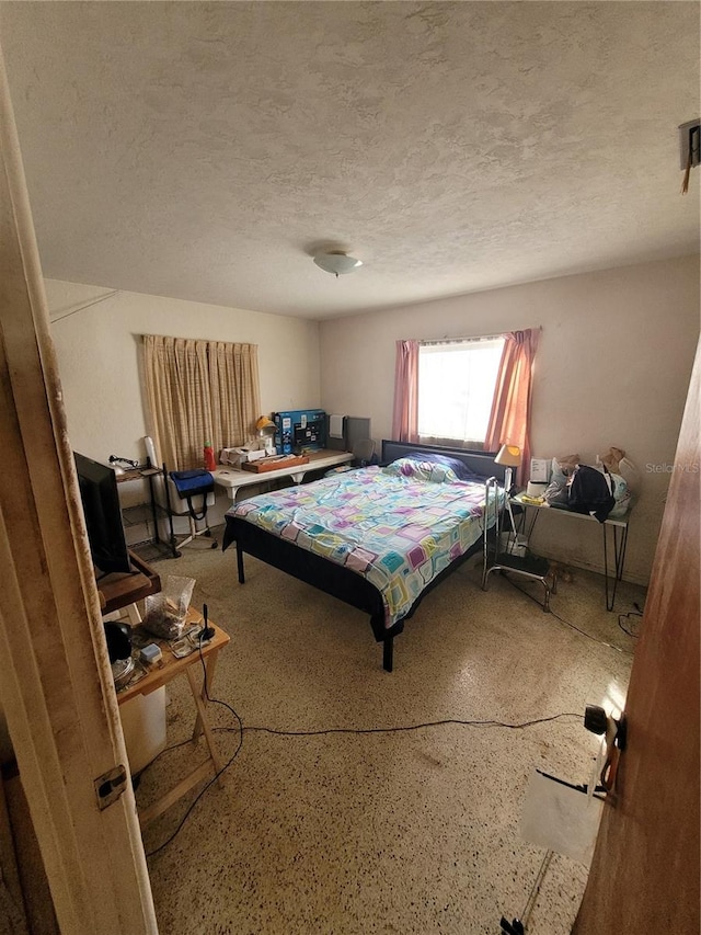 bedroom featuring a textured ceiling