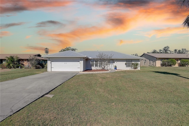 single story home with a garage and a lawn