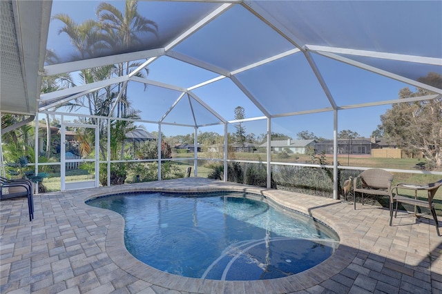 view of swimming pool featuring a patio and glass enclosure