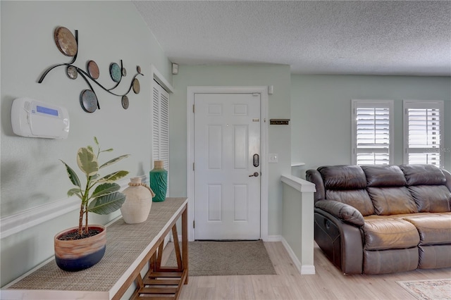 entryway featuring light hardwood / wood-style floors and a textured ceiling