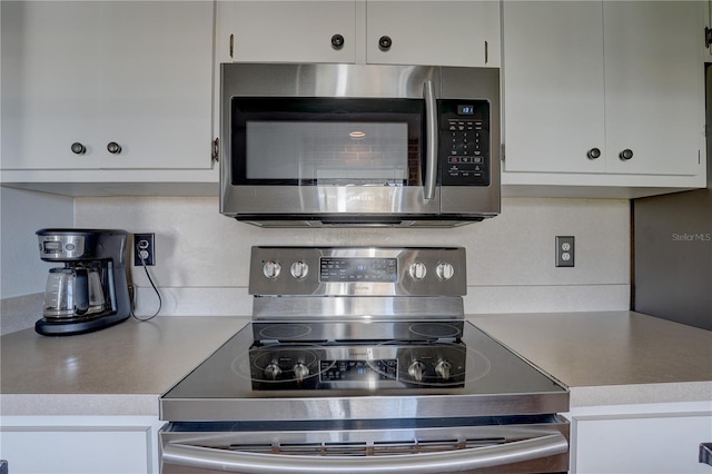 kitchen with stainless steel appliances and white cabinetry