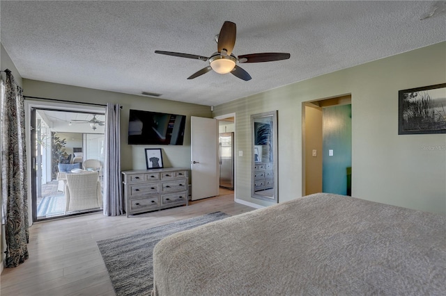 bedroom with stainless steel fridge, a textured ceiling, access to outside, ceiling fan, and light hardwood / wood-style floors