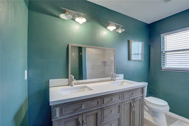 bathroom featuring hardwood / wood-style flooring, vanity, toilet, and a shower