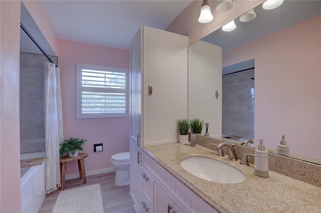 full bathroom with vanity, toilet, wood-type flooring, and shower / tub combo