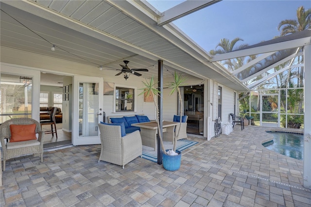 view of patio / terrace with ceiling fan, an outdoor hangout area, and glass enclosure