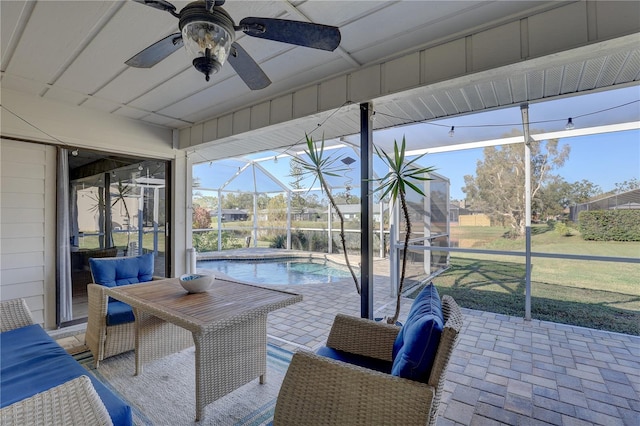 sunroom featuring ceiling fan