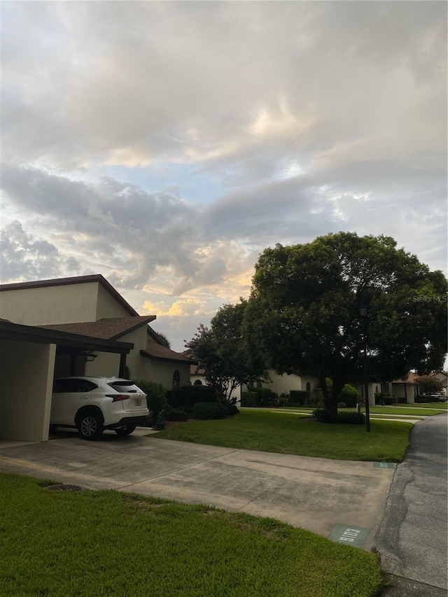 view of property exterior featuring a yard and a carport